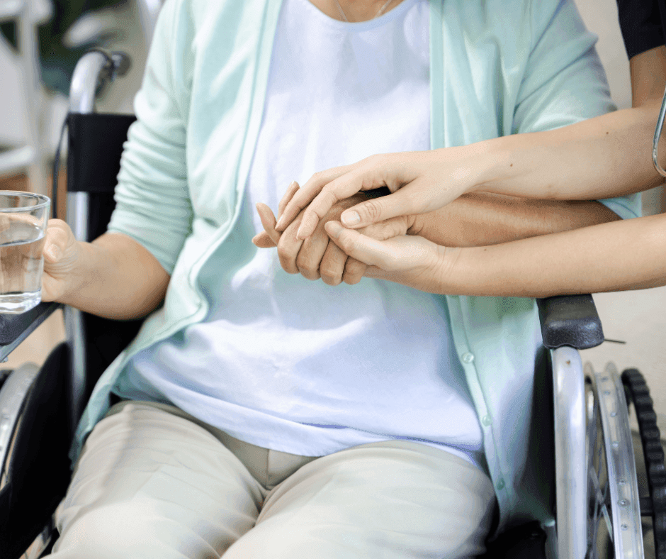 Nurse holding service user hand